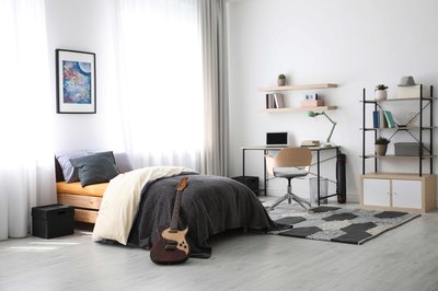 Modern teenager's room interior with workplace and bed